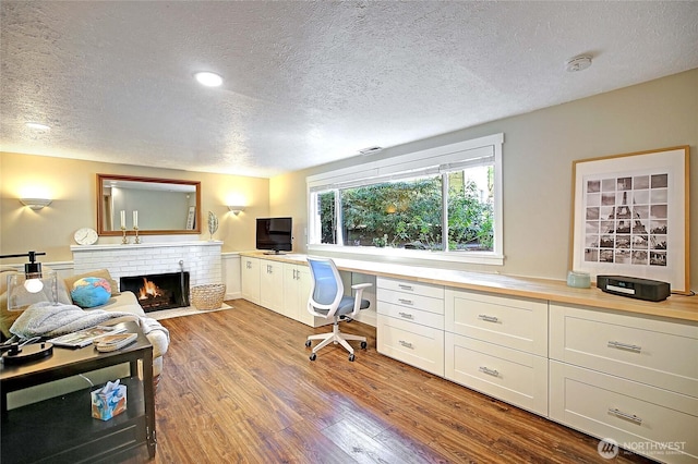 8612 NE 133rd St, Kirkland, WA 98034 - office featuring a textured ceiling, wood finished floors, and a brick fireplace