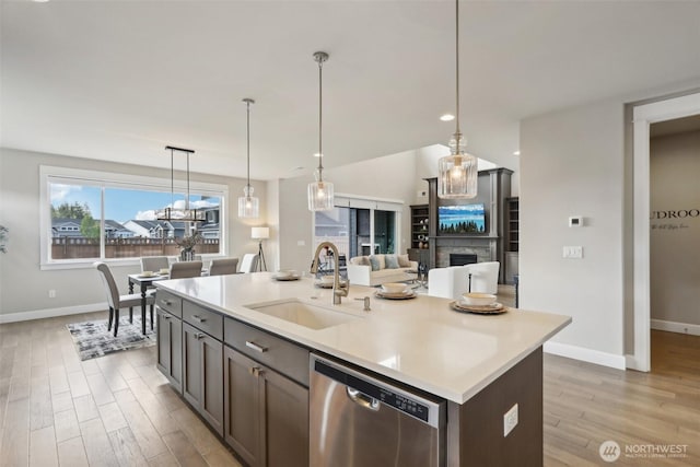 14651 Crestwood Pl E, Bonney Lake, WA 98391 - kitchen featuring dishwasher, a sink, baseboards, and light countertops