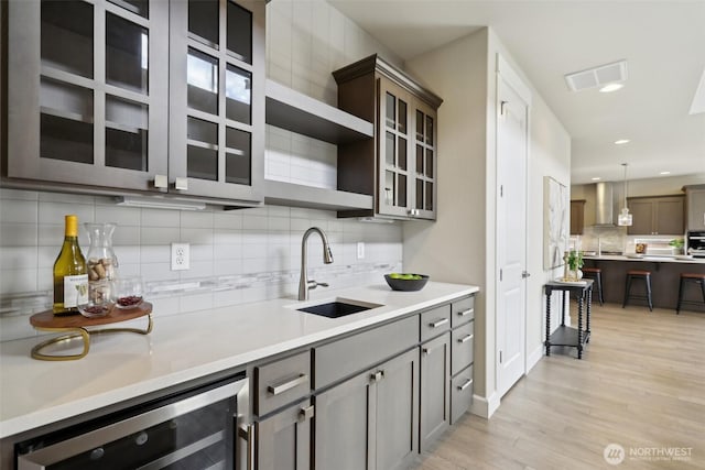 14651 Crestwood Pl E, Bonney Lake, WA 98391 - kitchen with wine cooler, wall chimney exhaust hood, tasteful backsplash, open shelves, and light wood finished floors