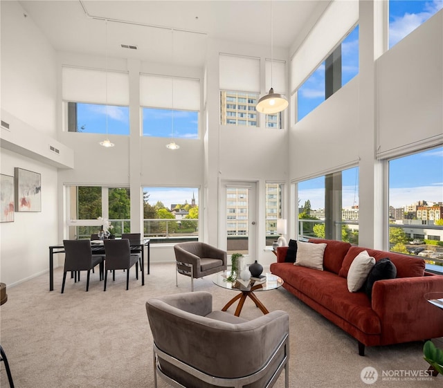 living room with carpet flooring and a towering ceiling
