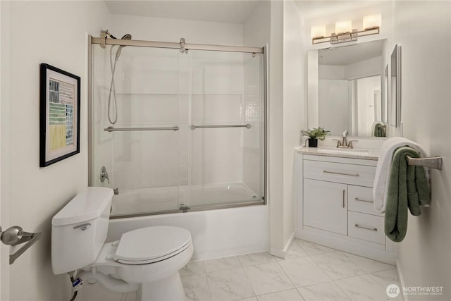 bathroom with marble look tiles, toilet, bath / shower combo with glass door, and vanity