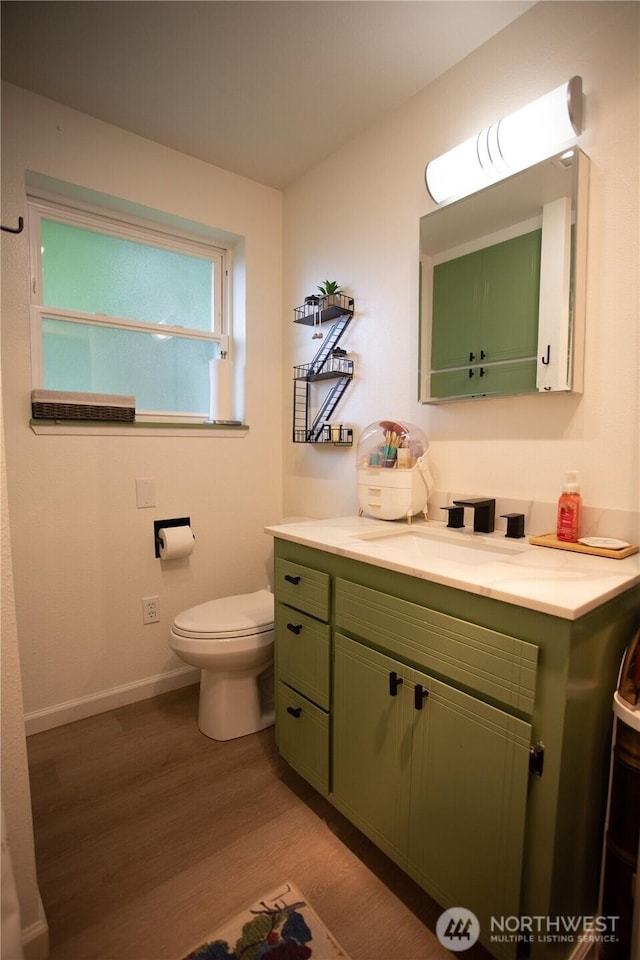 2622 Scotlac Ct SW, Olympia, WA 98512 - bathroom with wood finished floors, toilet, vanity, and baseboards