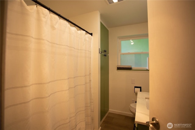 2622 Scotlac Ct SW, Olympia, WA 98512 - bathroom with toilet, wood finished floors, baseboards, and curtained shower
