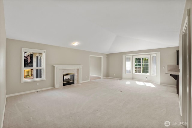 10308 139th Street Ct E, Puyallup, WA 98374 - unfurnished living room featuring light colored carpet, a high end fireplace, vaulted ceiling, and baseboards