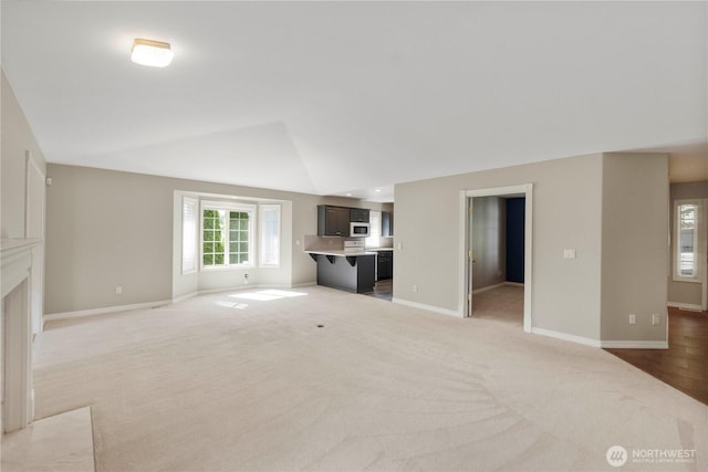 10308 139th Street Ct E, Puyallup, WA 98374 - unfurnished living room with light carpet, vaulted ceiling, and baseboards