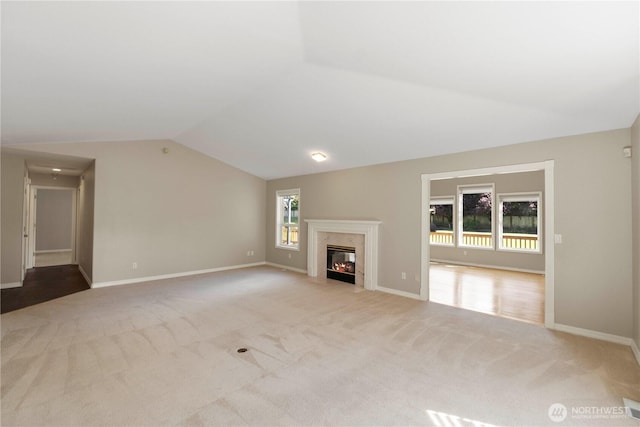 10308 139th Street Ct E, Puyallup, WA 98374 - unfurnished living room featuring vaulted ceiling, carpet floors, a premium fireplace, and baseboards