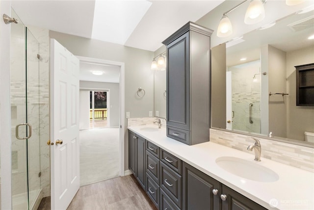 10308 139th Street Ct E, Puyallup, WA 98374 - full bathroom featuring a shower stall, double vanity, and tasteful backsplash
