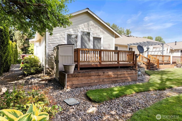 10308 139th Street Ct E, Puyallup, WA 98374 - back of property with a deck, a pergola, and a lawn