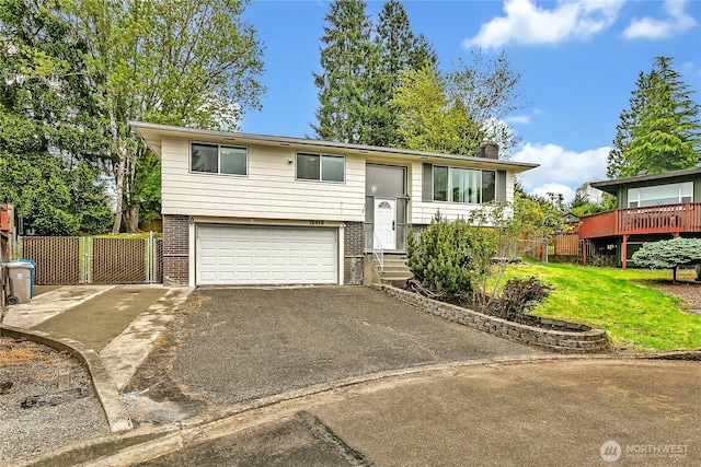 12416 SE 210th St, Kent, WA 98031 - raised ranch featuring driveway, an attached garage, brick siding, and a chimney