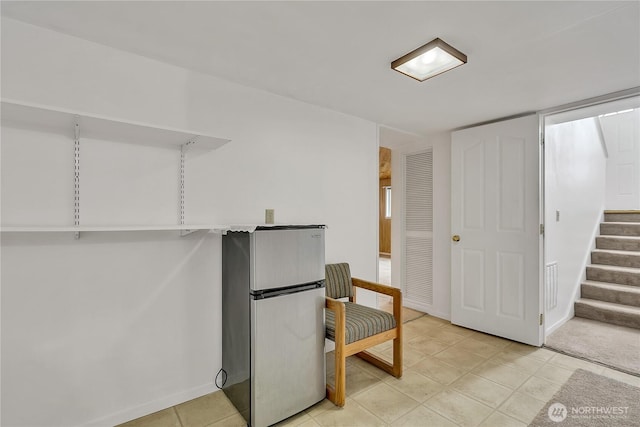 12416 SE 210th St, Kent, WA 98031 - basement featuring freestanding refrigerator, stairs, light tile patterned floors, and baseboards