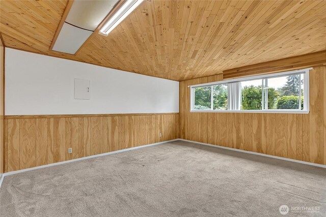 12416 SE 210th St, Kent, WA 98031 - empty room with wood ceiling, wooden walls, carpet floors, lofted ceiling, and a wainscoted wall