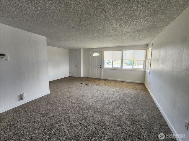 1476 W Sunset Dr, Moses Lake, WA 98837 - empty room featuring carpet floors, a textured ceiling, and baseboards