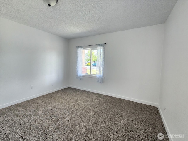 1476 W Sunset Dr, Moses Lake, WA 98837 - unfurnished room featuring dark carpet, a textured ceiling, and baseboards