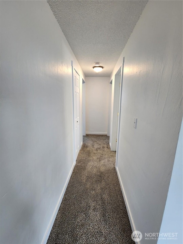 1476 W Sunset Dr, Moses Lake, WA 98837 - hall featuring a textured ceiling and baseboards