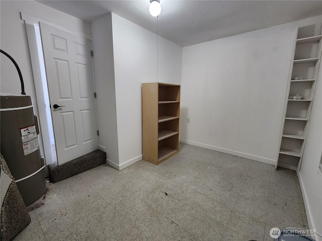 1476 W Sunset Dr, Moses Lake, WA 98837 - unfurnished bedroom with baseboards, electric water heater, and tile patterned floors