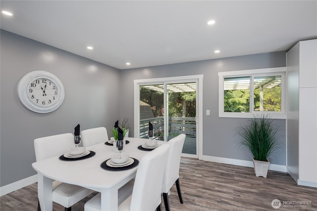 dining room featuring baseboards, wood finished floors, and recessed lighting