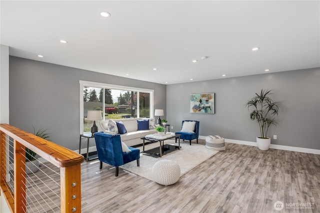 living room featuring wood finished floors, recessed lighting, and baseboards