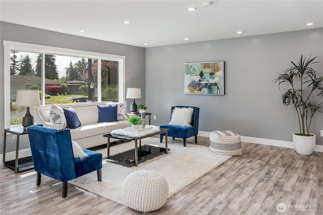 living area with wood finished floors, recessed lighting, and baseboards