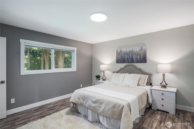 bedroom featuring wood finished floors and baseboards
