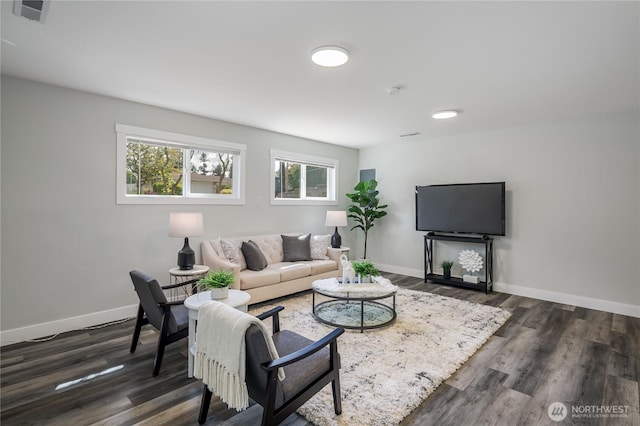 living room featuring dark wood-type flooring and baseboards