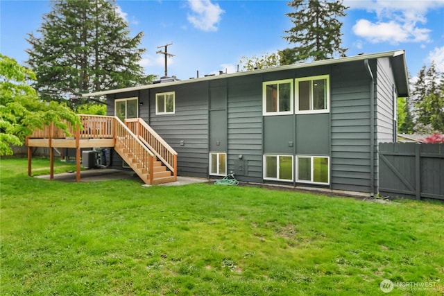 rear view of property with a wooden deck, stairway, and central AC