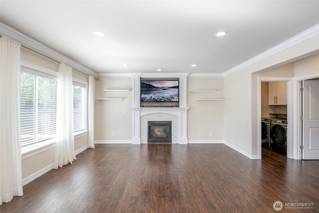 1226 57th Ct SE, Auburn, WA 98092 - unfurnished living room with washing machine and clothes dryer, crown molding, dark wood finished floors, baseboards, and a glass covered fireplace