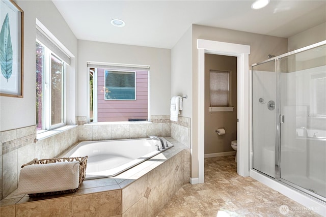 full bathroom with toilet, a shower stall, a bath, and recessed lighting