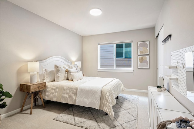 bedroom with light carpet and baseboards