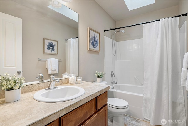 full bathroom featuring a skylight, vanity, toilet, and shower / bath combination with curtain
