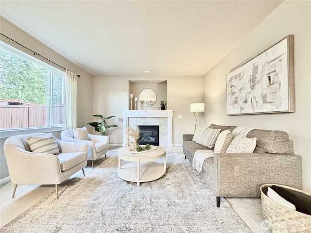 living room featuring a fireplace and baseboards