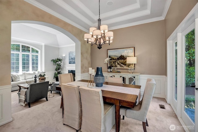 19016 NE 127th St, Redmond, WA 98052 - dining room with a chandelier, arched walkways, a decorative wall, light carpet, and crown molding