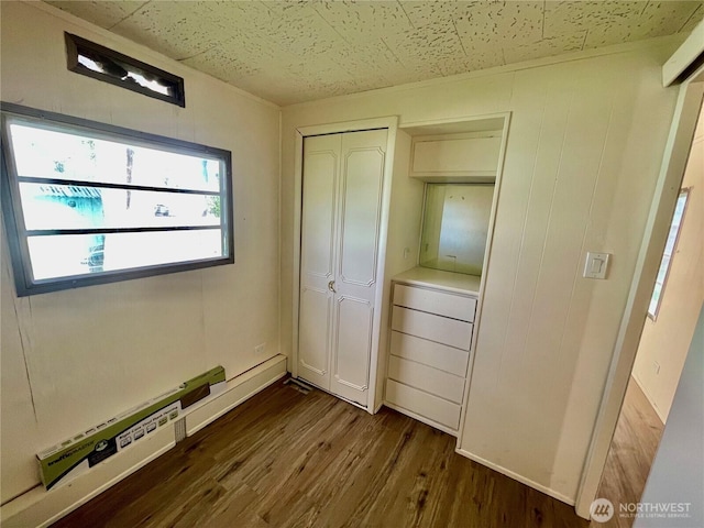 101 5th St, Starbuck, WA 99359 - unfurnished bedroom with a baseboard radiator, dark wood-style floors, and a closet