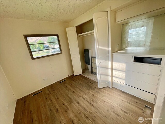 101 5th St, Starbuck, WA 99359 - unfurnished bedroom with light wood-style floors and a textured ceiling