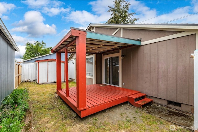 727 Salzburg Ln SE, Olympia, WA 98513 - wooden terrace featuring a storage shed, fence, and an outbuilding