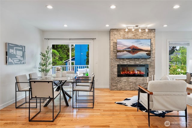 2333 NE 94th St, Seattle, WA 98115 - dining area with a stone fireplace, wood finished floors, baseboards, and recessed lighting