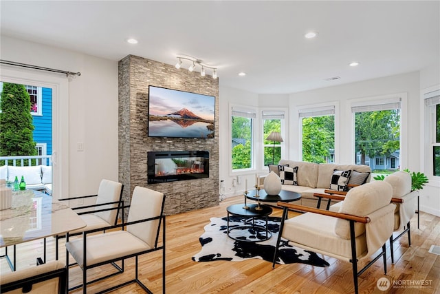 2333 NE 94th St, Seattle, WA 98115 - living area with wood finished floors, healthy amount of natural light, a fireplace, and recessed lighting