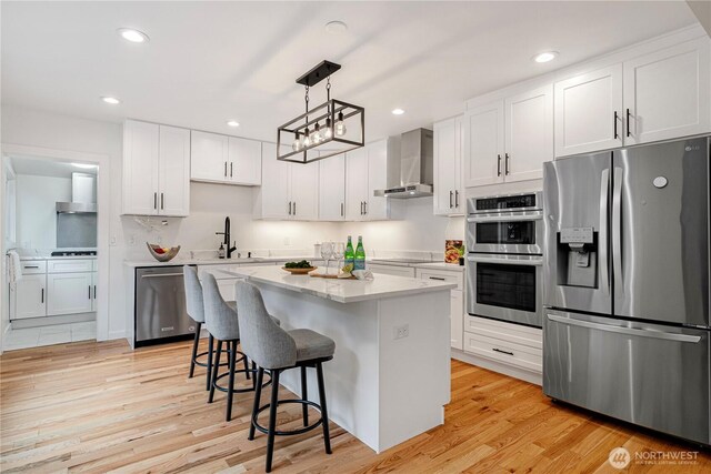 2333 NE 94th St, Seattle, WA 98115 - kitchen featuring stainless steel appliances, wall chimney exhaust hood, a breakfast bar, a sink, and white cabinets