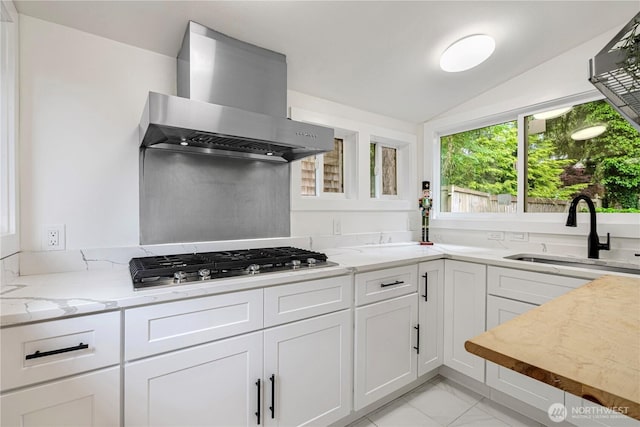 2333 NE 94th St, Seattle, WA 98115 - kitchen with wall chimney exhaust hood, a sink, stainless steel gas stovetop, vaulted ceiling, and light marble finish flooring