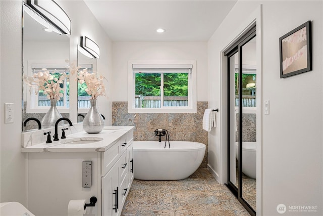 2333 NE 94th St, Seattle, WA 98115 - full bath with toilet, a freestanding bath, vanity, tile walls, and wainscoting