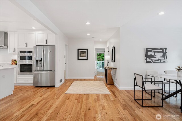 2333 NE 94th St, Seattle, WA 98115 - kitchen with appliances with stainless steel finishes, recessed lighting, light wood-type flooring, white cabinets, and light countertops