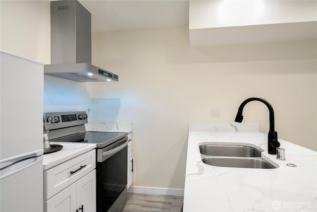 2333 NE 94th St, Seattle, WA 98115 - kitchen featuring electric range, wall chimney exhaust hood, a sink, freestanding refrigerator, and light stone countertops