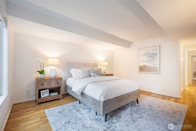 bedroom featuring light wood-style floors and baseboards