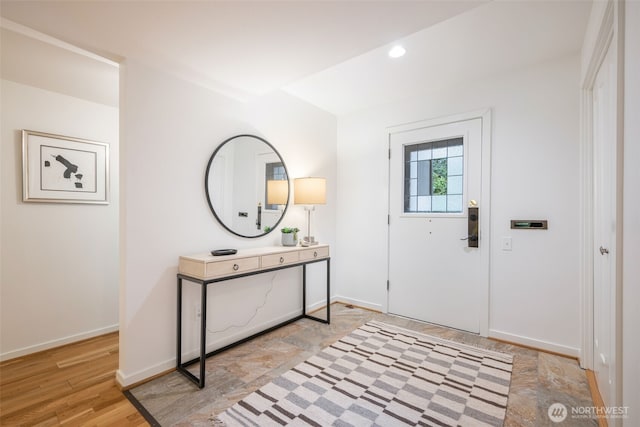 foyer entrance with baseboards, light wood-style flooring, and recessed lighting
