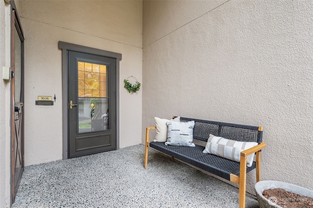 entrance to property featuring stucco siding