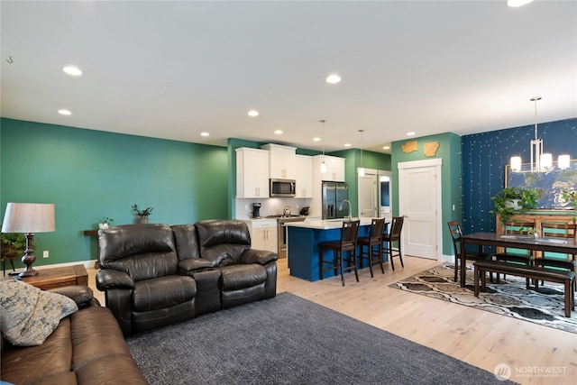 210 E Cedarland Ln, Allyn, WA 98524 - living room with a chandelier, light wood-style floors, recessed lighting, and baseboards