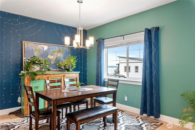 210 E Cedarland Ln, Allyn, WA 98524 - dining space featuring a chandelier, baseboards, and wood finished floors
