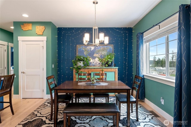 210 E Cedarland Ln, Allyn, WA 98524 - dining area with a chandelier, wood finished floors, baseboards, recessed lighting, and an accent wall