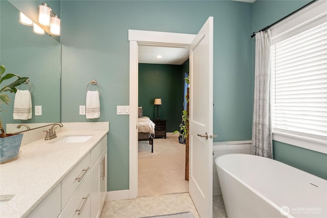 210 E Cedarland Ln, Allyn, WA 98524 - full bathroom with a freestanding tub, double vanity, ensuite bath, and tile patterned floors