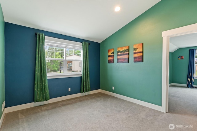 210 E Cedarland Ln, Allyn, WA 98524 - carpeted empty room featuring vaulted ceiling and baseboards