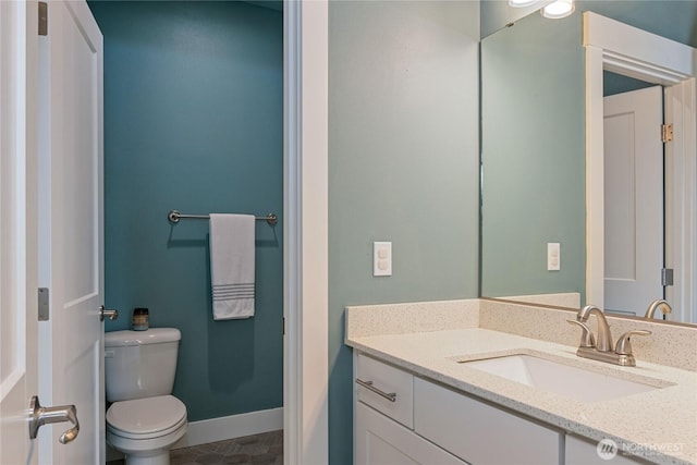 210 E Cedarland Ln, Allyn, WA 98524 - bathroom featuring toilet, vanity, tile patterned floors, and baseboards
